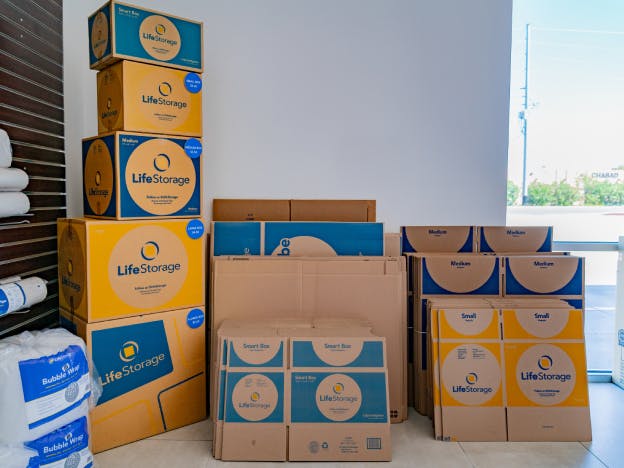 Various sizes and types of Life Storage moving boxes on display in a Life Storage facility office. 