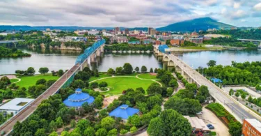 Aerial from drone of Downtown Chattanooga, TN skyline with Coolidge Park and Market Street Bridge on a cloudy day