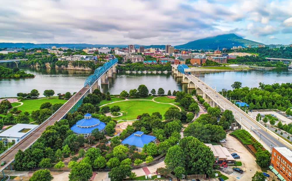 Aerial from drone of Downtown Chattanooga, TN skyline with Coolidge Park and Market Street Bridge on a cloudy day